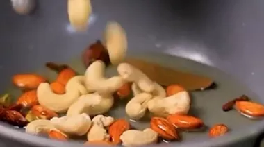 Phulkari Pulao with saffron rice, nuts, peas, and paneer served in a brass bowl 2